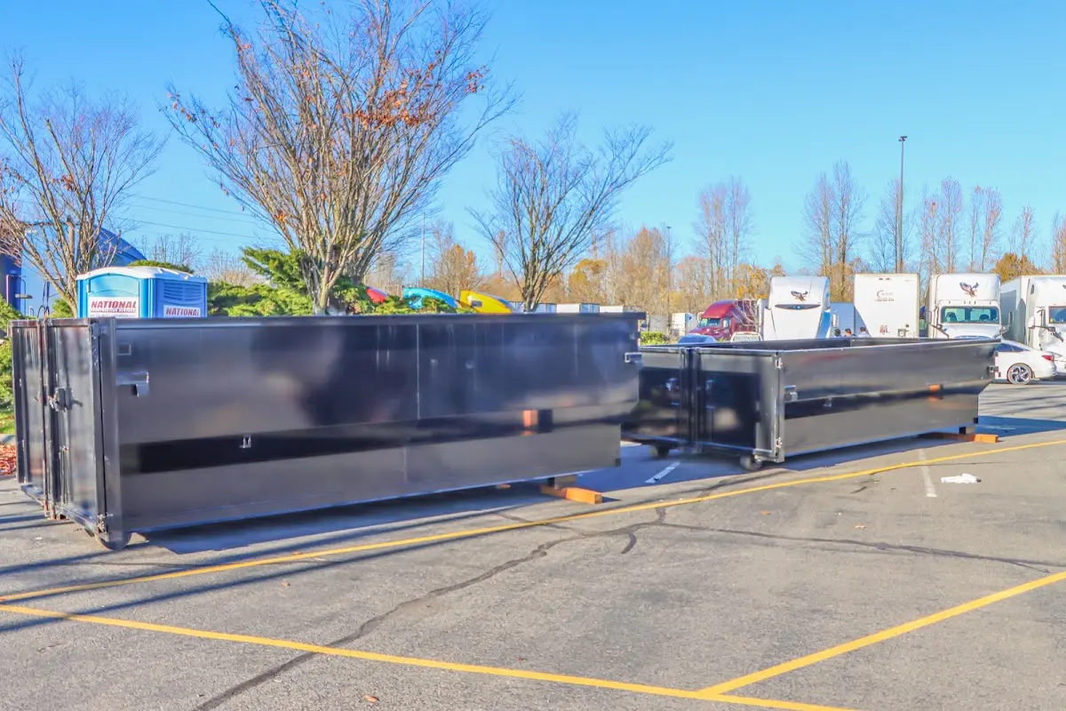 Professional dumpster rental service with roll-off container on residential driveway in North Castle